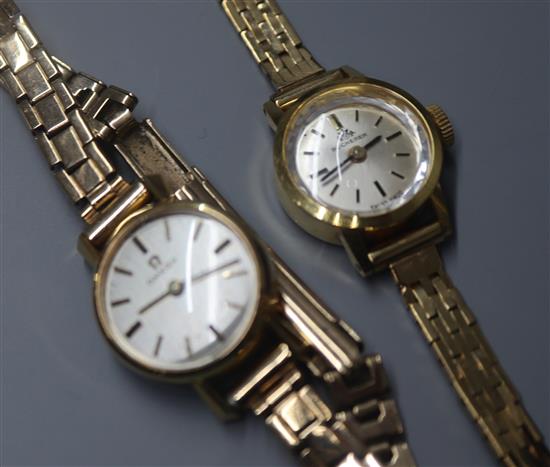 A ladys Omega 9ct gold wristwatch and a similar Bucherer wristwatch, both with 9ct gold bracelets.